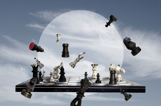 Chess pieces and chess board on sky background