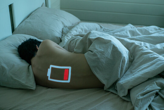 Tired young woman in bed
