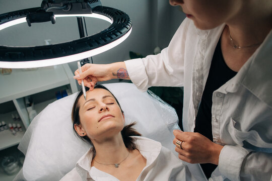 Cosmetologist working with a client