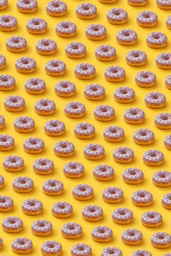 Pattern of glazed donuts with sprinkles