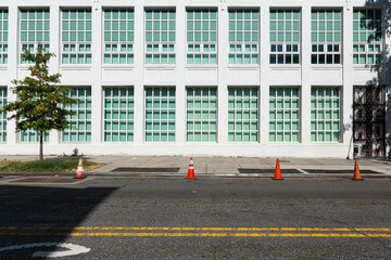 empty street with a white  building in the background