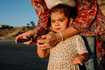 Mother tests blood droplet of girl