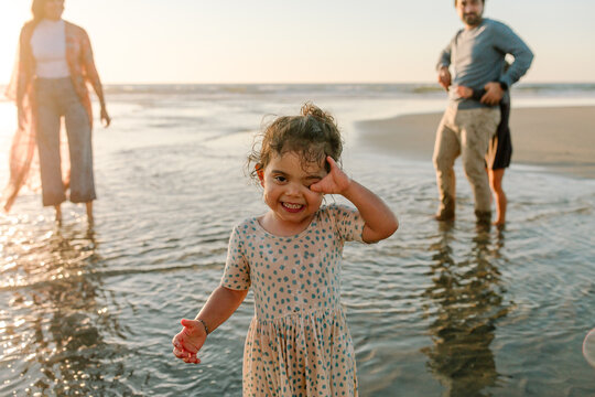 Girl with limb.difference wading in ocean