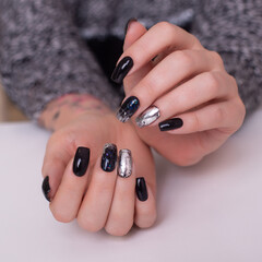 
Beautiful female hands with fashion manicure nails, black gel polish