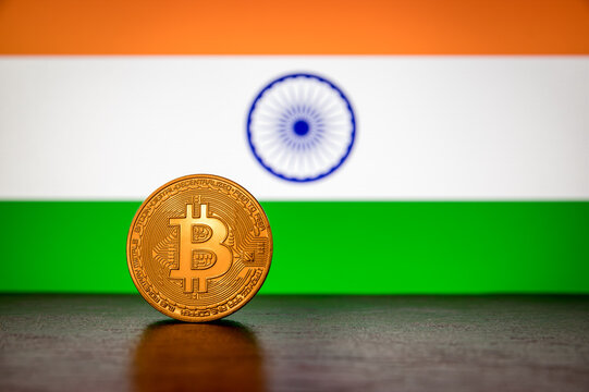 Golden physical Bitcoin with India flag in the background