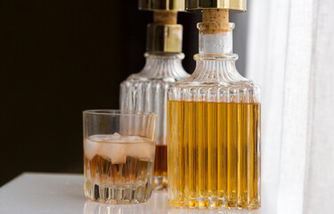 Luxury glass bottles with different alcoholic spirits inside, copy space photo