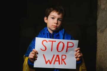 Russia's war against Ukraine in 2022. A sad boy is hiding in a bomb shelter from Russian missiles....