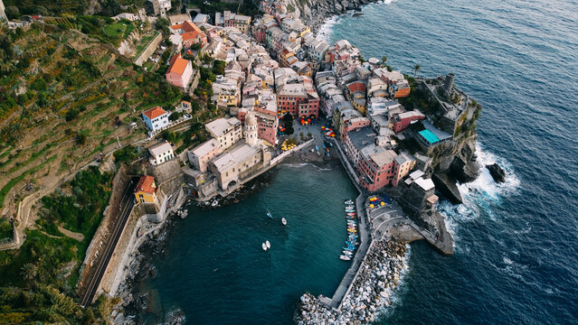 Beautiful aerial view of the village of Vernazza filmed by a drone. Is one of five famous colorful villages of Cinque Terre National Park in Italy, suspended between sea and land on sheer cliffs. 