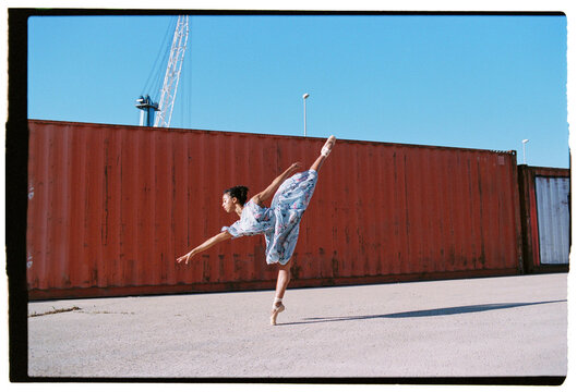 Elegant ballerina in summer dress standing on tiptoe