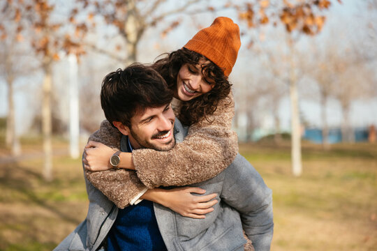 Gleeful couple having fun in autumn park