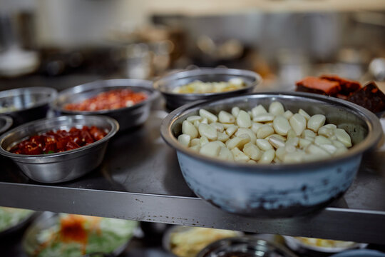 Raw Garlic And Red Peppers In A Restaurant Kitchen