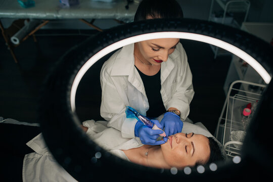 Beauty specialist doing procedure in her studio