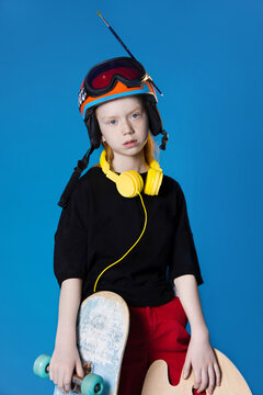 Overloaded child with different equipment in studio
