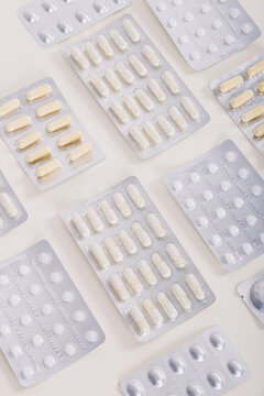 White pills in a blister packages on a white background. Medicine