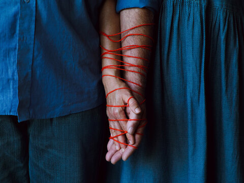 Elderly couple holding hands
