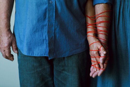Elderly couple holding hands