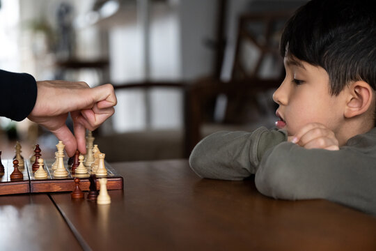 Little kid playing chess