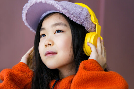 Girl is listening music by earphones 
