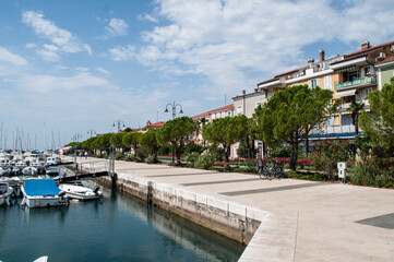 Waterfront and harbor and boats in summer by the sea in Izola, Slovenia.