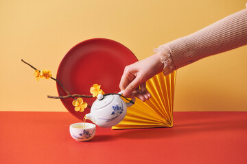 Vietnamese New Year decorations on red table over yellow background