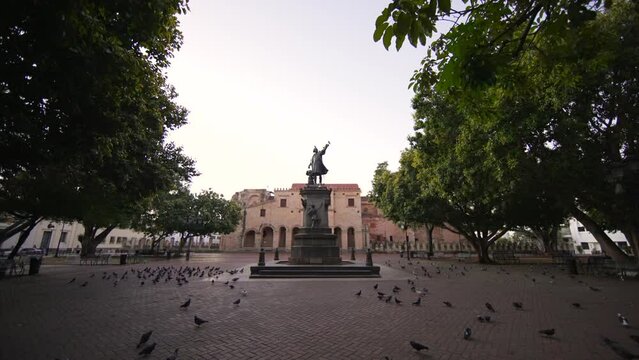 Motion forward to monument to Christopher Columbus on the main square of Columbus Park without people in the Colonial city. Early morning in the tourist zone of Santo Domingo