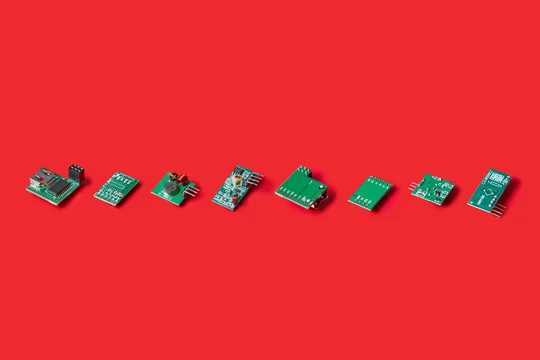 Line of electronic microchips on red background
