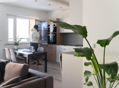 Man Looking Into The Fridge At Home