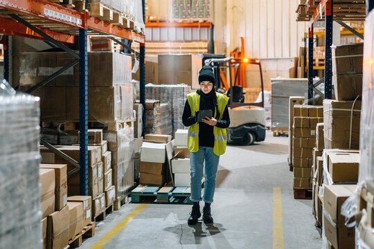 Female worker preparing order for delivery in warehouse