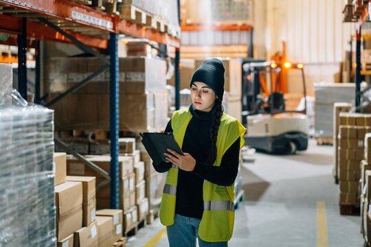 Female worker preparing order for delivery in warehouse