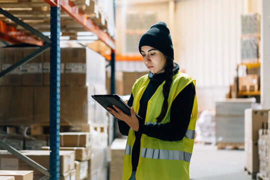 Female worker preparing order for delivery in warehouse