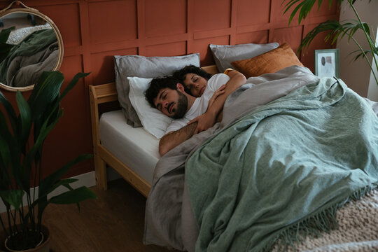 Peaceful couple sleeping in cozy bedroom
