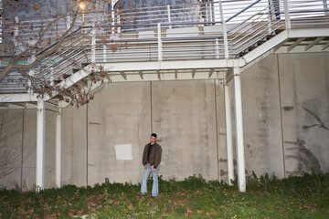 Man standing against factory building