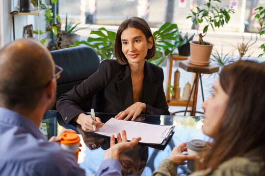 Smiling sexologist during appointment with couple