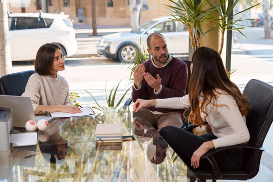 Young spouses talking during session with sexologist