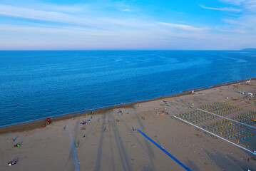 Aerial view of Rimini beach with people and blue water.