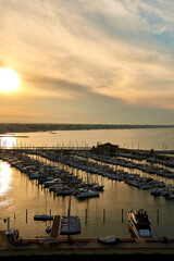 Obraz premium Aerial view of Rimini sea port with ships and blue water.