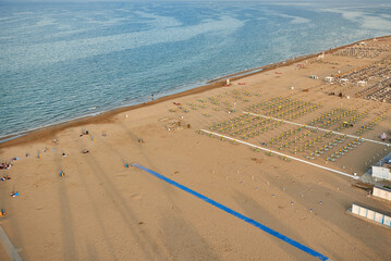 Aerial view of Rimini beach with people and blue water.