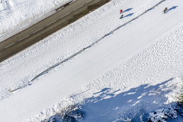 Skier running on the track. Snow white field. Aerial.