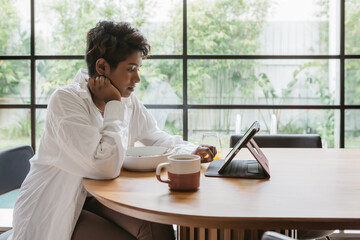 Woman reading a pc device while working from home
