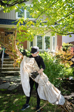 Boy Carrying Corn Stalks Fall Halloween Decoration