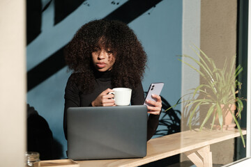 Woman working on laptop at cafe