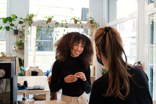 Waitress Taking Order From Client at cafe bar