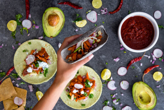 Hand holding a Mexican pork taco