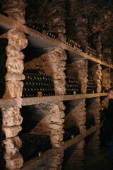 Old wine cellar full of wine bottles
