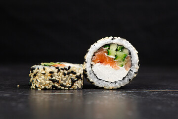 Japanese rolls with salmon and cucumber in sesame