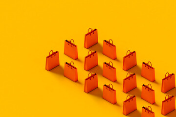 rows of Orange shopping bag on a yellow background