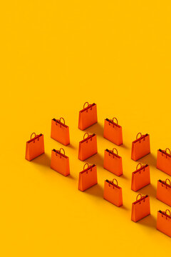 Orange shopping paper bag on a yellow background