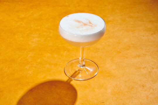 Cocktails in Coupe Glasses with Foam and Limes