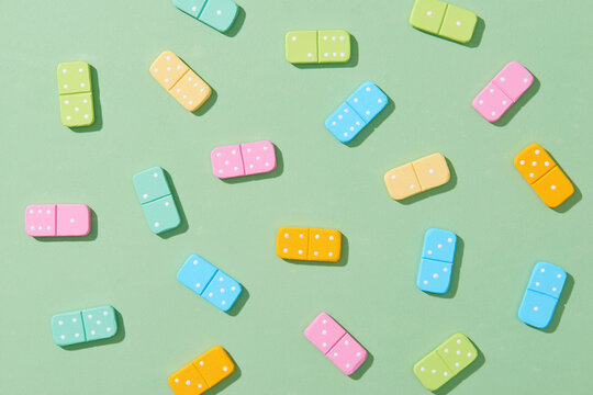 Colorful Dominoes Lying In A Pile On Green Light Background