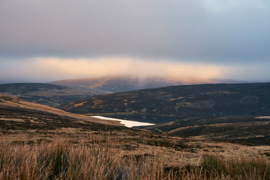 Sunset breaking through over Glen Franka Reservoir in Leadhills
